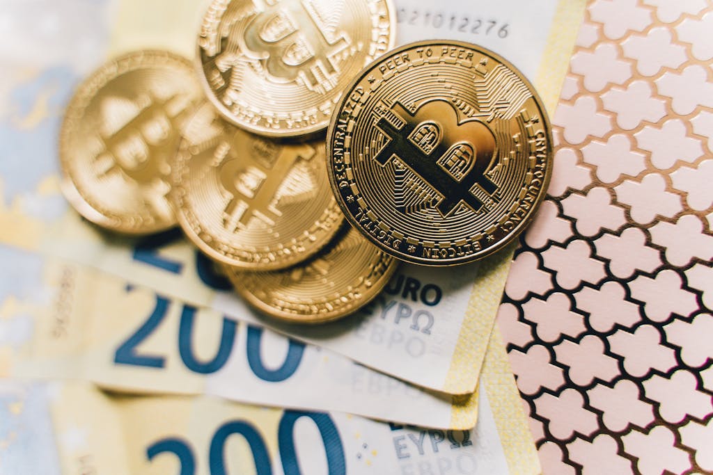 Close-up of Bitcoin coins on Euro banknotes, symbolizing cryptocurrency exchange.
