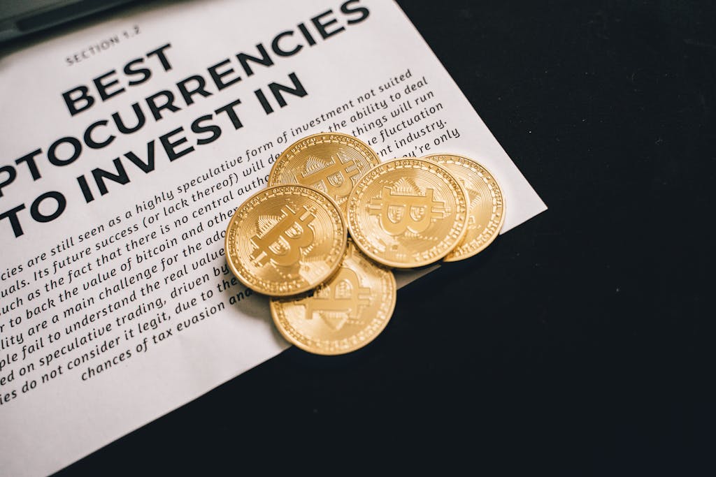 Close-up of Bitcoin coins on investment document promoting cryptocurrencies.